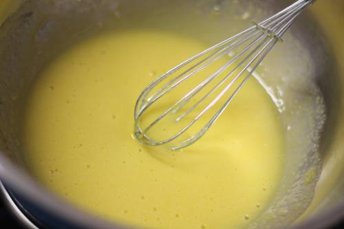A photo of a whisk in a bowl of sauce
