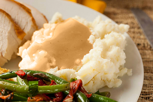 A photo of a plate of food including mashed potatoes dressed with low FODMAP gravy