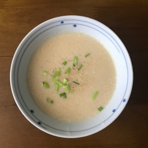 A bowl of cheesy baked potato soup