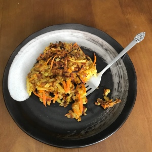 A photo of curry hash browns on a plate. 
