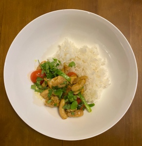 A plate of chicken kebat with rice