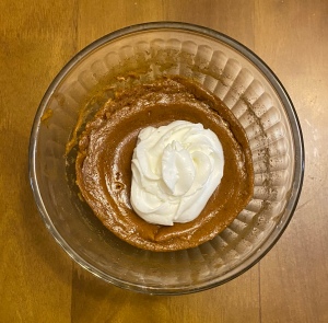 Top down view of a pumpkin pie made in a mixing bowl